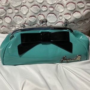 Sourpuss high gloss teal floozy purse in a retro style.